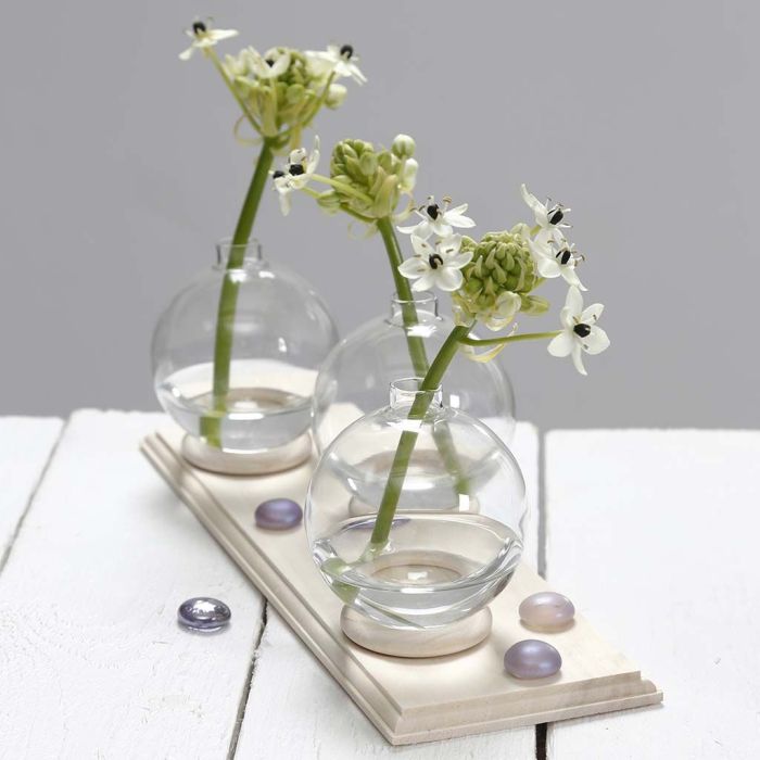 A small Vase made from a Glass Bauble standing on a Curtain Ring