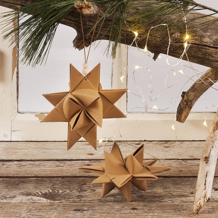 A Christmas Star woven from Faux Leather Paper Star Strips with a Leather Cord with wooden Beads for hanging