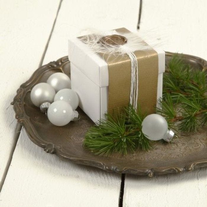 A Folded Box with Gold Paper and Feathers