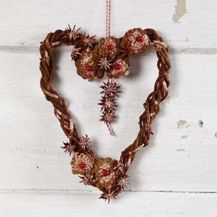 A natural woven heart-shaped Garland with Cones & Star Anise