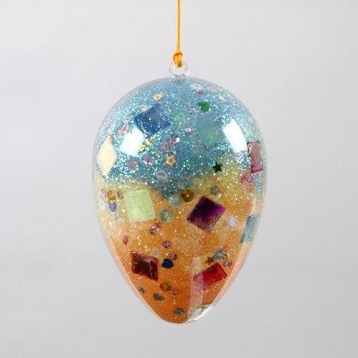 A two-part transparent Acrylic Egg with Sequins & Glitter inside