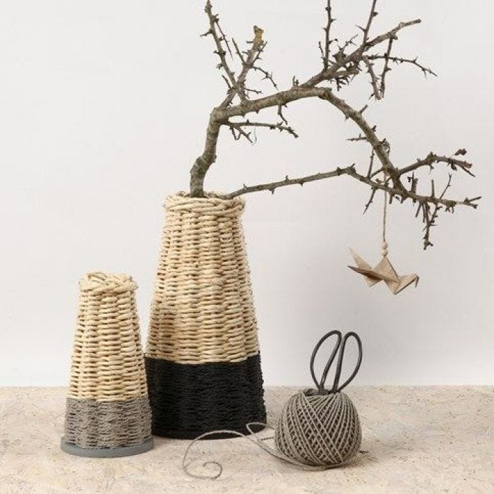 A tall woven Basket with a firm Base