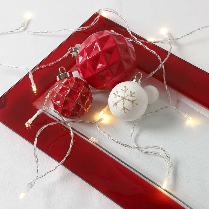 A painted and varnished Terracotta Bauble decorated with gold raised Lines