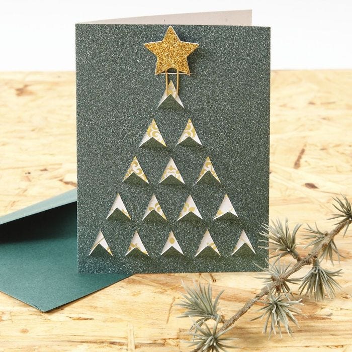 A Christmas Card with a graphic cut-out Christmas Design on the Front