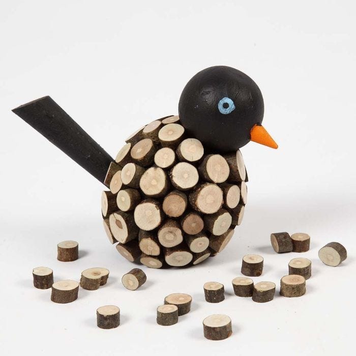 A painted Bird decorated with small wooden Discs with Bark