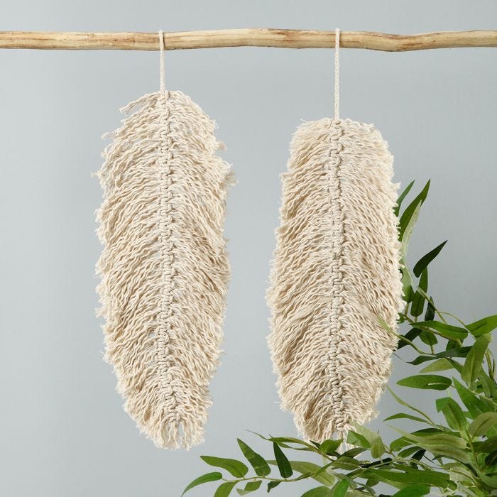 A macramé hanging decoration shaped like a leaf