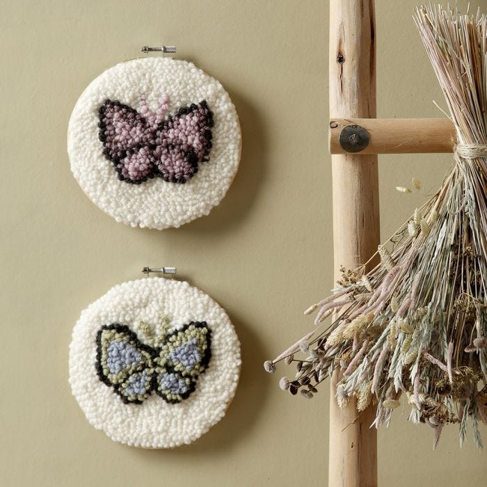 Punched needle embroidered butterflies in an embroidery frame