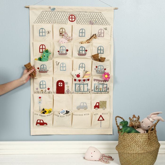 A hanging organiser decorated like a playhouse with iron-on foil