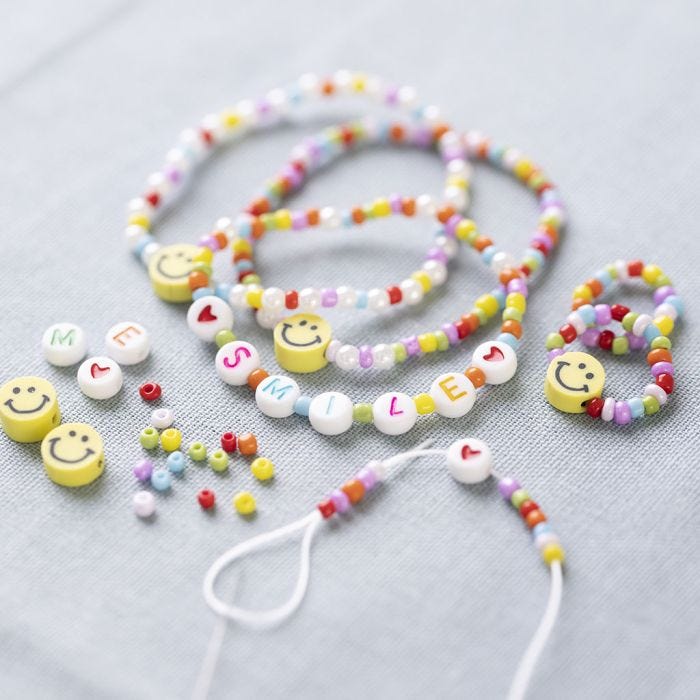 Bracelet and rings with letter beads and smiley beads