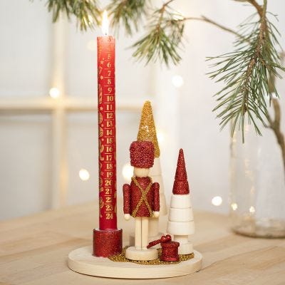 A Candlestick decorated with a Nutcracker Figure