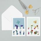 A Greeting Card with dried Flowers behind a Picket Fence