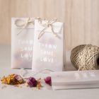 A vellum paper bag with dried flowers for confetti