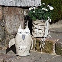 A decorative Owl and a Bag Vase for the Garden