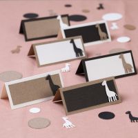 Place cards with punched-out giraffes