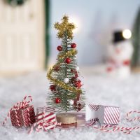 The elf decorates the Christmas tree