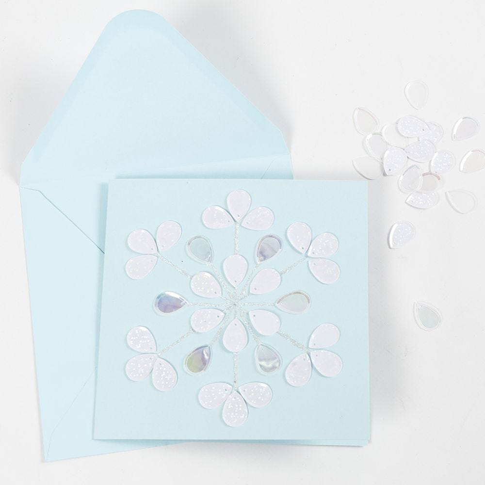 A greeting card decorated with glitter glue and sequins